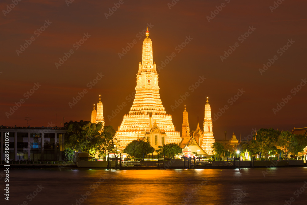 View of the main prang of Wat Arun Buddhist Temple in night lighting. Bangkok, Thailand