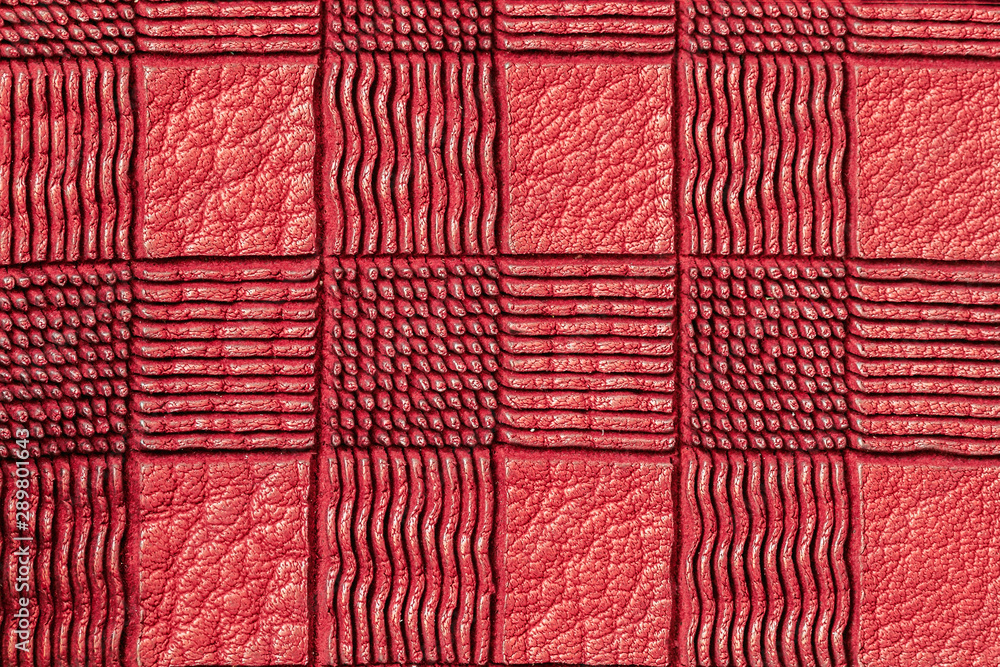 Fototapeta premium Texture of genuine plaid leather close-up, red color. For background, copy space