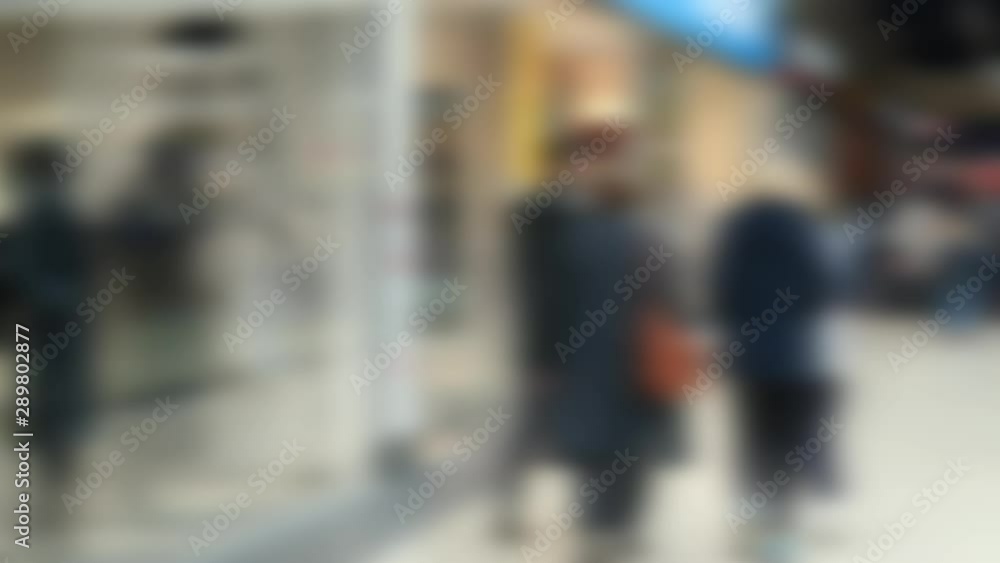 People at the supermarket, blurred background. People at the supermarket, blurred background.