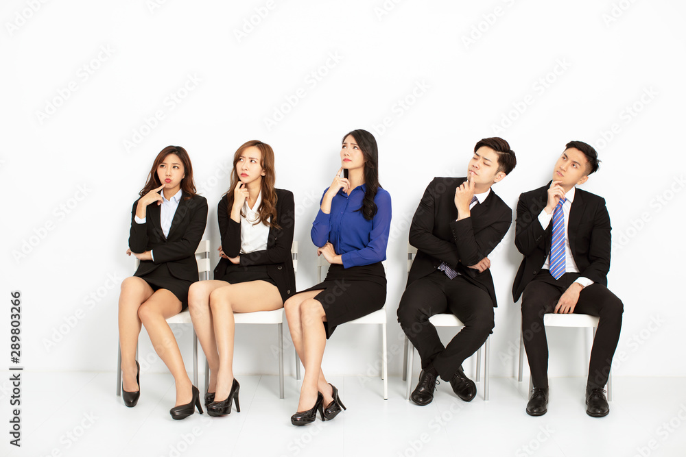 asian business people sitting on the chairs in a row asian business people sitting on the chairs in a row