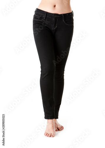 Image of woman legs wearing black jeans.