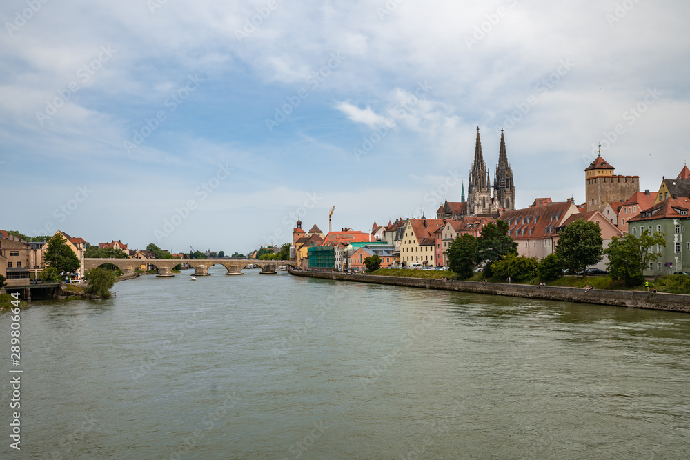 Fototapeta premium Panorama view of the stone bridge and historical old town of Regensburg or Ratisbon on river side of Danube