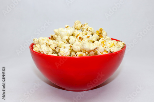 Popcorn in red with caramel on white background