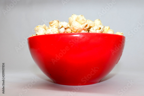Popcorn in red with caramel on white background