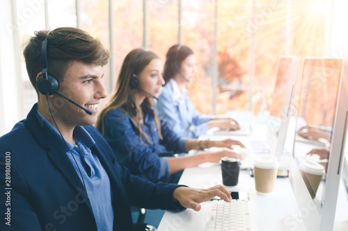 Call Center Service. Photo of customer support or sales agent.  Help line answering and telemarketing. Male caller or receptionist phone operator.Copy space for some text, advertising or slogan.