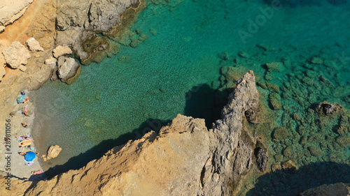Aerial drone photo of emerald secluded crystal clear sea rocky cove of Ble limanaki or Blue Harbour in famous island of Astypalaia, Dodecanese, Greece