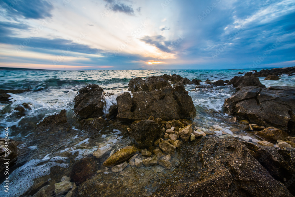 sunset on croatian stony beach