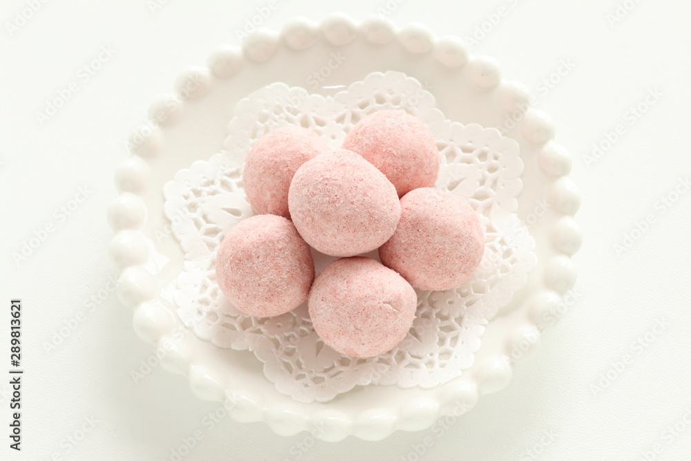 home bakery, pink cookie ball on white dish home bakery, pink cookie ball on white dish