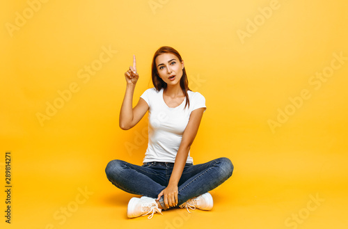 girl in a white t-shirt, came up with a great idea, on a yellow background
