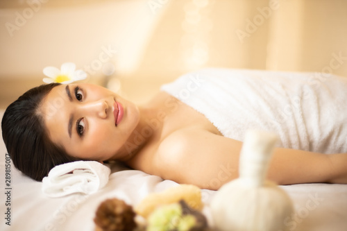 Asian Beautiful  young and healthy woman in spa salon. Massage treatment spa room  . Traditional medicine and healing concept.