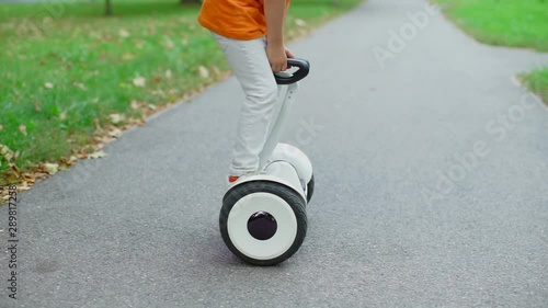 the child becomes and climbs off the platform of the GyroScooter photo