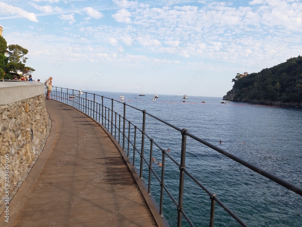 Portofino, Italy - 08/29/2019: Beautiful bay with colorful houses in Portofino in sumer days. Hiking around the ligurian mountains with amazing panoramic view. Portofino, Italy - 08/29/2019: Beautiful bay with colorful houses in Portofino in sumer days. Hiking around the ligurian mountains with amazing panoramic view.