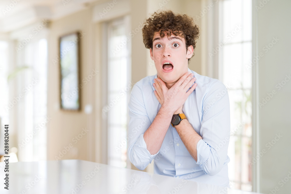 Young business man with curly read head shouting suffocate because painful strangle. Health problem. Asphyxiate and suicide concept.