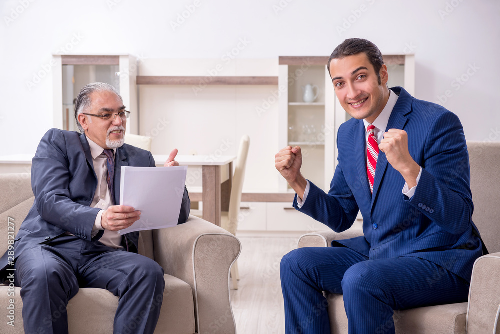 Two businessman discussing business in office Two businessman discussing business in office