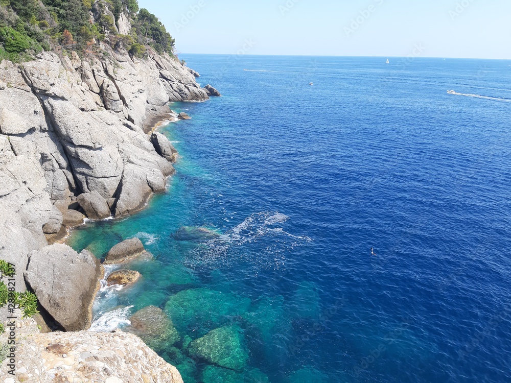 Portofino, Italy - 08/29/2019: Beautiful bay with colorful houses in Portofino in sumer days. Hiking around the ligurian mountains with amazing panoramic view.