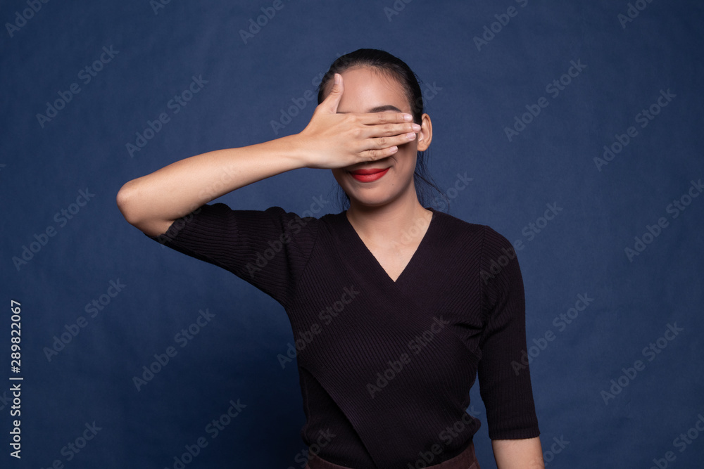 Young Asian woman close her eyes with hand.