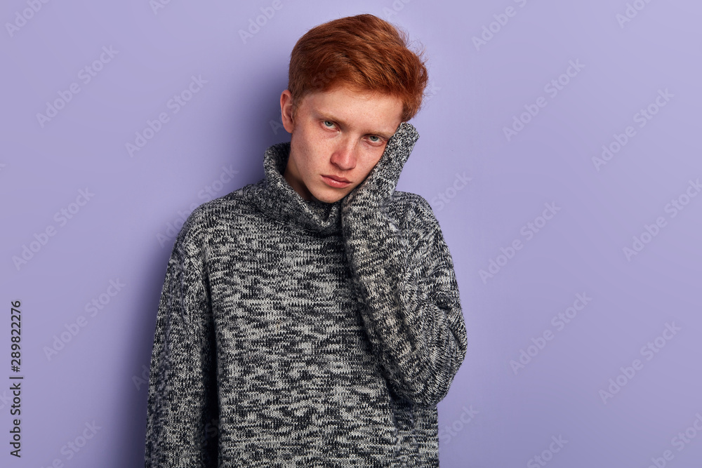 Close up portrait of nervous unhappy troubled handsome man touching his cheek, he has terrible toothache. isolated on blue background copy-space, close up portrait. Close up portrait of nervous unhappy troubled handsome man touching his cheek, he has terrible toothache. isolated on blue background copy-space, close up portrait.