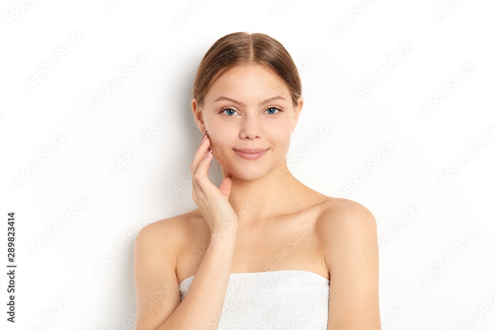 young beautiful model wearing white towel touching her face posing to the camera. close up portrait. beauty, healthy lifestyle young beautiful model wearing white towel touching her face posing to the camera. close up portrait. beauty, healthy lifestyle