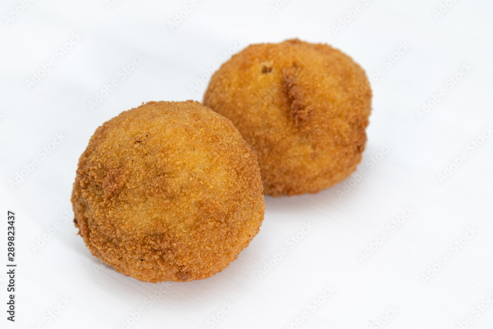 Sicilian Arancino or Arancina. A typical Sicilian street food. Sicilian Arancino or Arancina. A typical Sicilian street food.