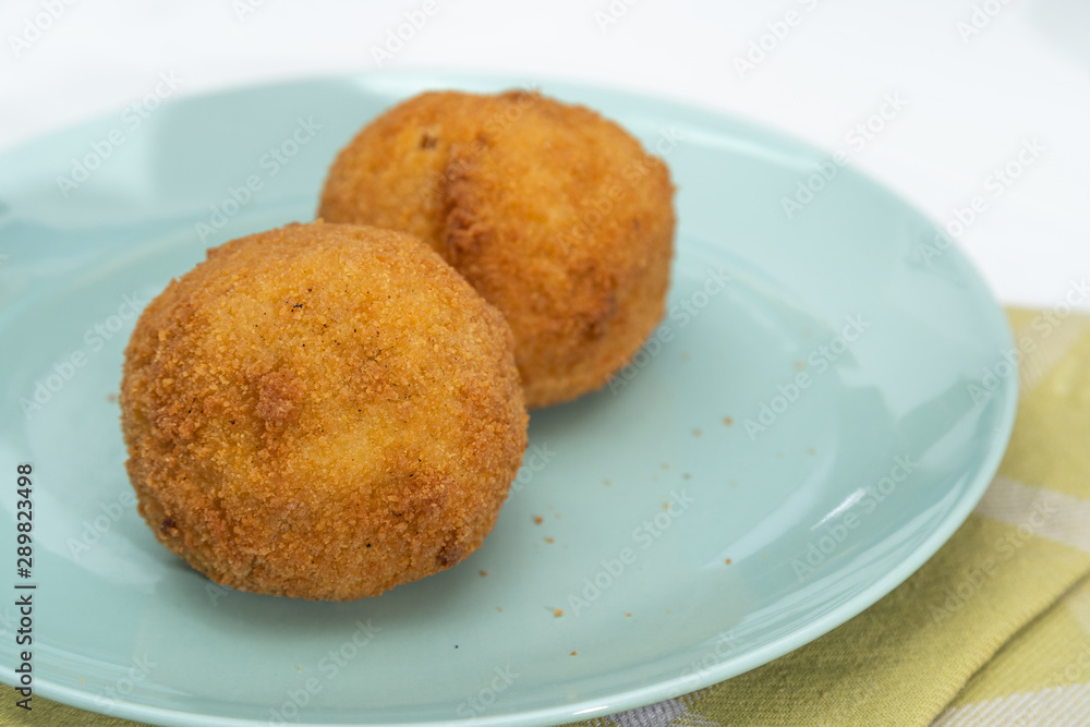 Sicilian Arancino or Arancina. A typical Sicilian street food. Sicilian Arancino or Arancina. A typical Sicilian street food.