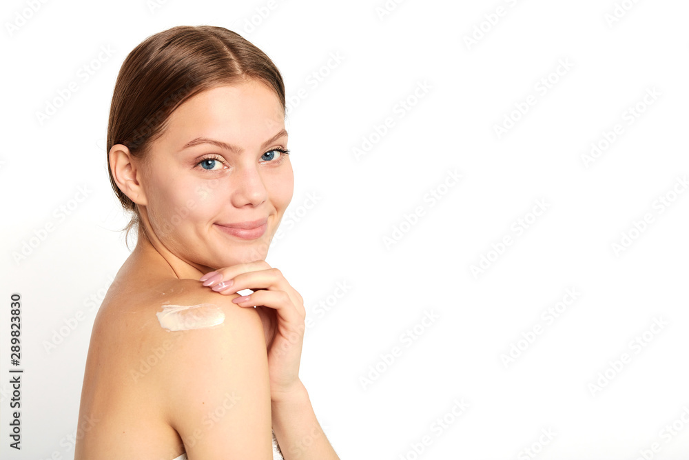 nude young woman using a cream. close up portrait, studio shot. copy space, girl takes care of shoulder. place for advert, text nude young woman using a cream. close up portrait, studio shot. copy space, girl takes care of shoulder. place for advert, text