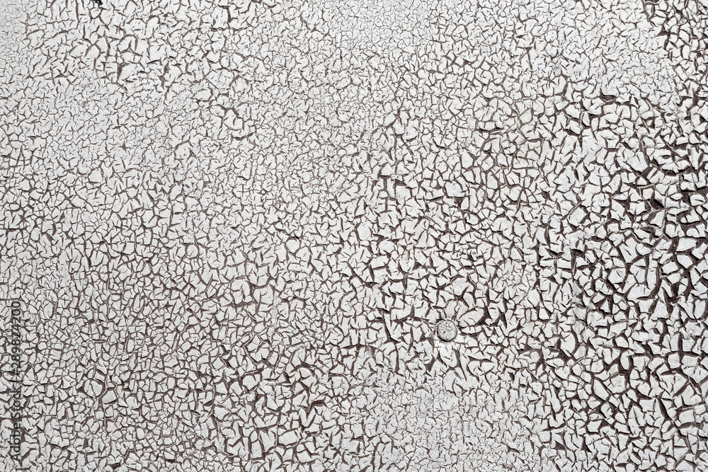 Cracked surface texture. Many small cracks on white paint. Old metal wall. Perfect for background and design. Cracked surface texture. Many small cracks on white paint. Old metal wall. Perfect for background and design.