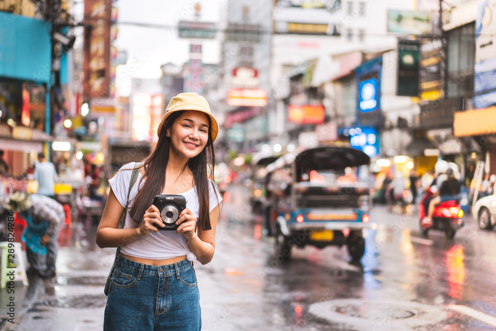 Asian traveler woman with camera at chinatown.