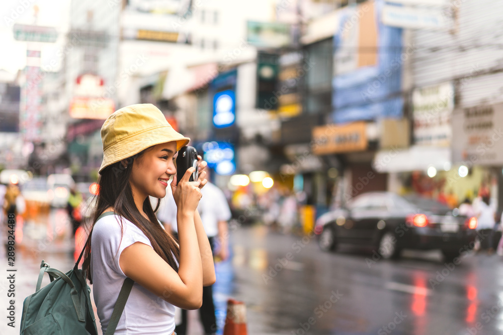 Fototapeta premium Asian traveler woman taking photo with instant camera