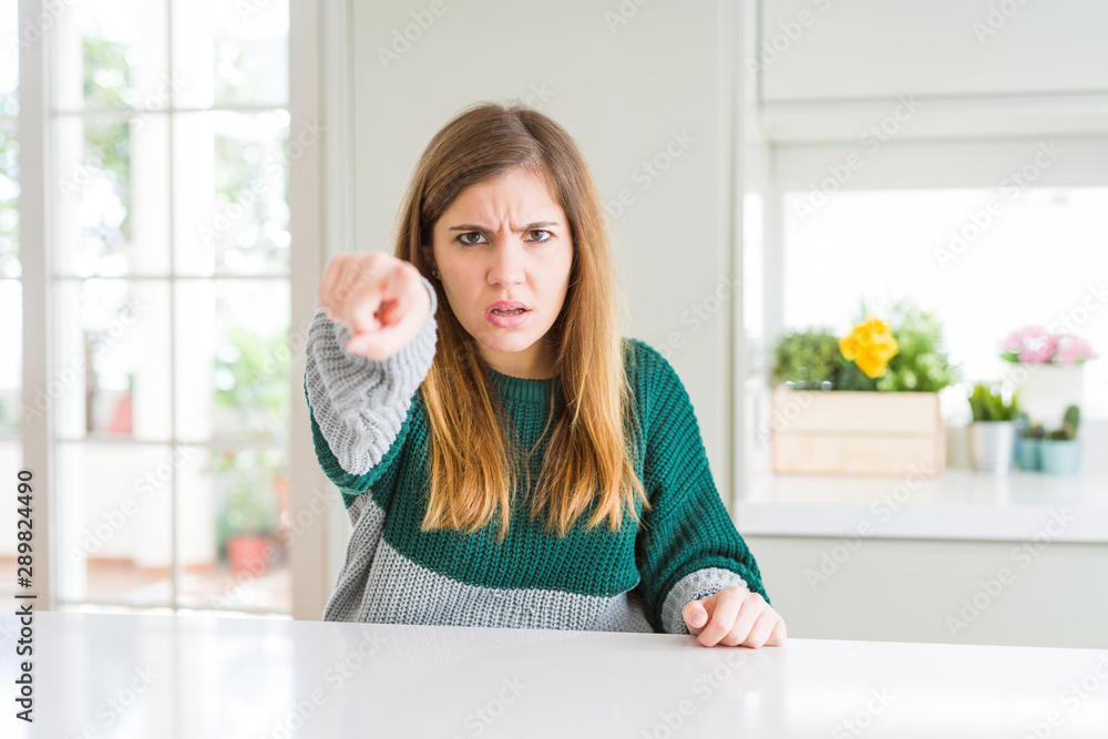 Young beautiful plus size woman wearing casual striped sweater pointing displeased and frustrated to the camera, angry and furious with you Young beautiful plus size woman wearing casual striped sweater pointing displeased and frustrated to the camera, angry and furious with you