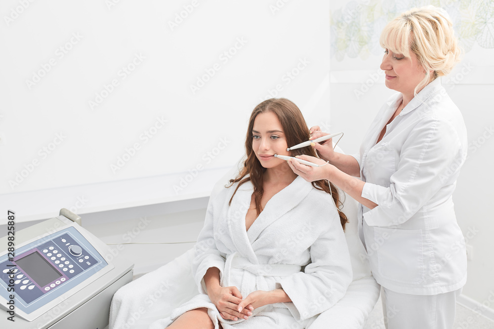 attractive female client enjoying microcurrent therapy, close up photo. job, profession, beauty, skin, face care attractive female client enjoying microcurrent therapy, close up photo. job, profession, beauty, skin, face care