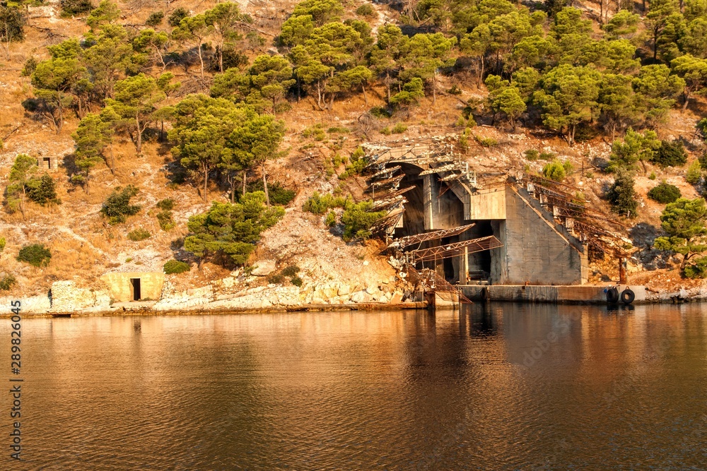 Submarine and ship bunker on Lastovo island, Croatia. Concrete bunker shelter for submarines in adriatic sea. Morning in the Bay of Smrka. Submarine and ship bunker on Lastovo island, Croatia. Concrete bunker shelter for submarines in adriatic sea. Morning in the Bay of Smrka.