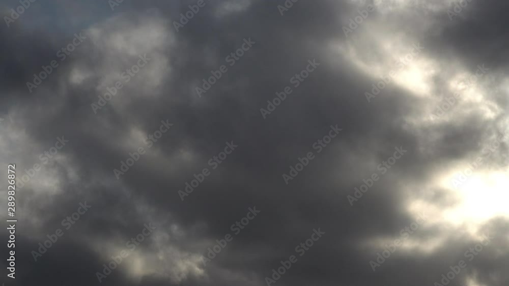 UK September 2019 - Time lapse of stormy clouds passing overhead as sunbeams and blue sky peek through. UK September 2019 - Time lapse of stormy clouds passing overhead as sunbeams and blue sky peek through.