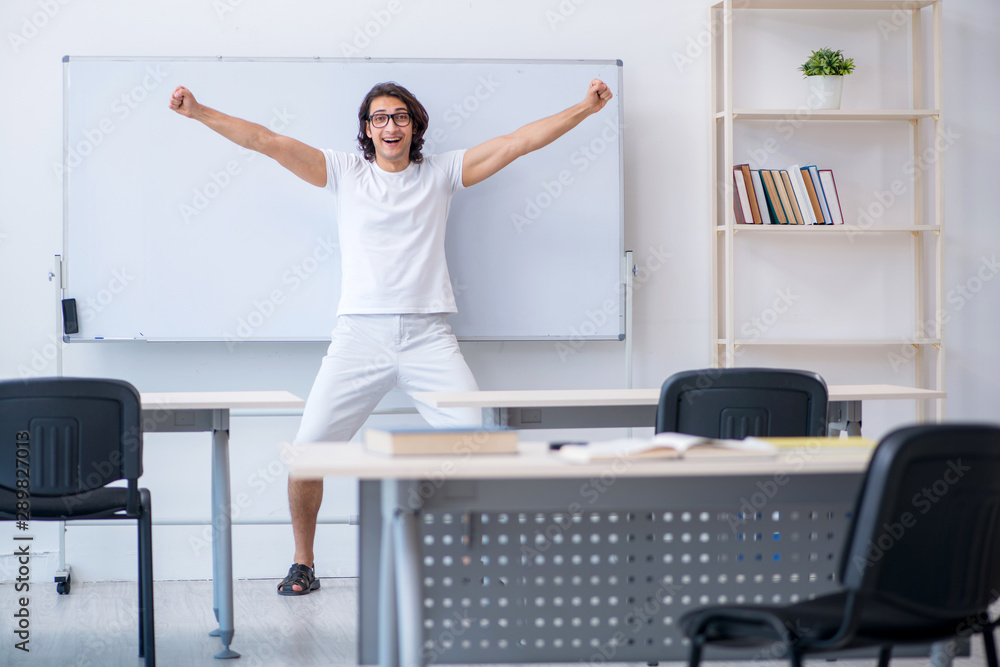 Young male student in front of whiteboard Young male student in front of whiteboard