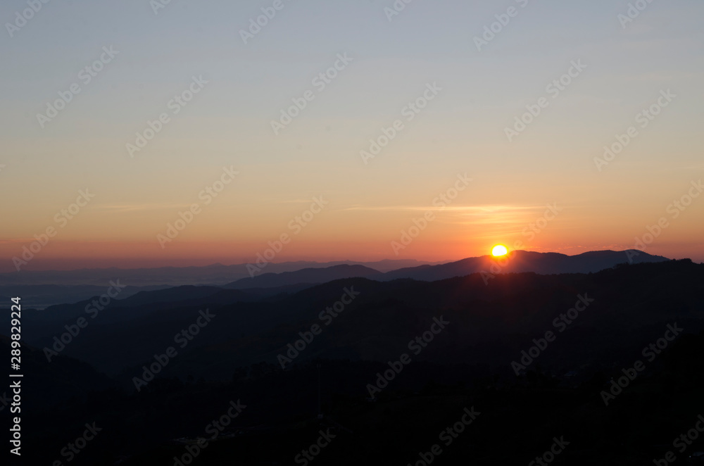 Rising sun on hill with orange sky. Feel warm for a new bright day.