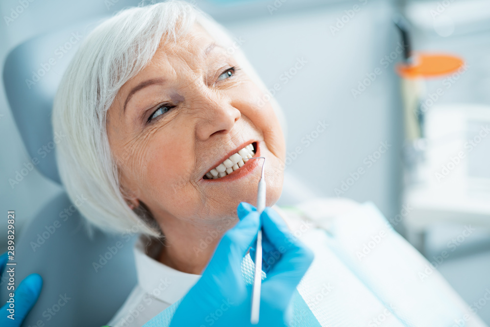 Smiling mature lady having a checkup at dentist Smiling mature lady having a checkup at dentist
