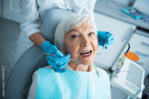 Adult woman is getting her teeth checked