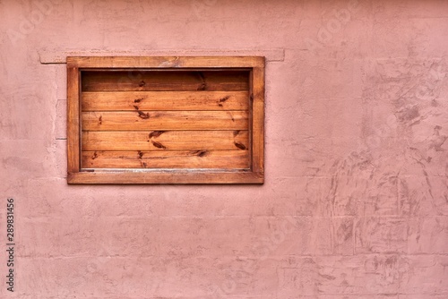 Old plastered wall with a small closed niche in vintage style photo