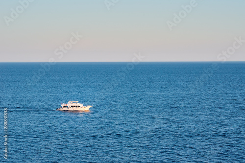 White ship in sea or ocean against sunset © Lazy_Bear