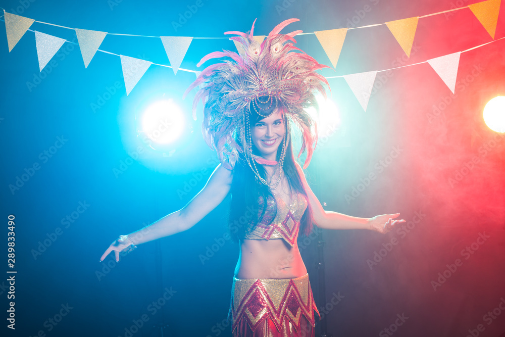 Carnival, dancer and holiday concept - Beauty brunette woman in cabaret suit and headdress with natural feathers and rhinestones.