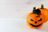 Halloween. Pumpkin on a white wooden background. Horisontal orientation, copy space.