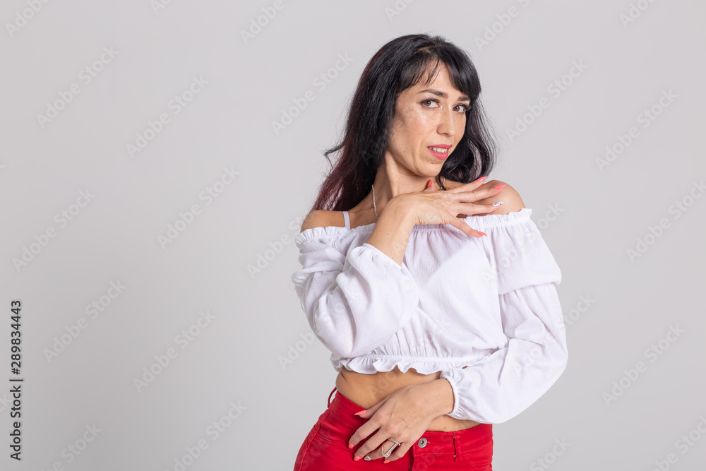 Latin dance, bachata lady, jazz modern and vogue dance concept - Beautiful young woman dancing on white background with copy space Latin dance, bachata lady, jazz modern and vogue dance concept - Beautiful young woman dancing on white background with copy space