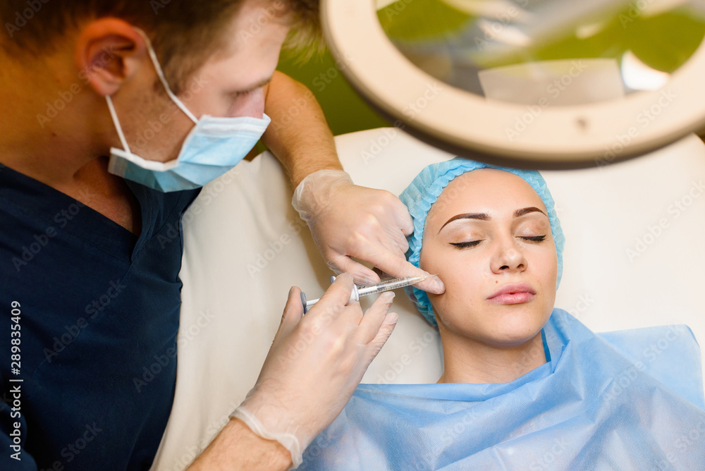 Woman makes rejuvenating facial injections procedure for cheek ...