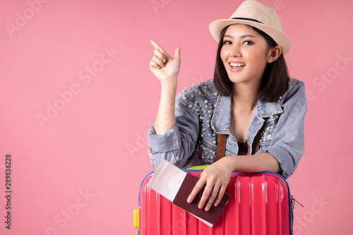 Tourist woman in summer casual clothes.Asian Smiling woman .Passenger traveling abroad to travel on colour background.Asian woman going to summer vacation.Travel trip funny. photo