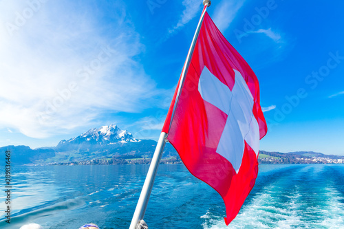 View of Pilatus Mountain and swiss flag from Lake Lucerne, Switzerland