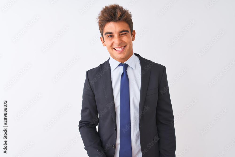 Young handsome businessman wearing suit standing over isolated white background winking looking at the camera with sexy expression, cheerful and happy face. Young handsome businessman wearing suit standing over isolated white background winking looking at the camera with sexy expression, cheerful and happy face.