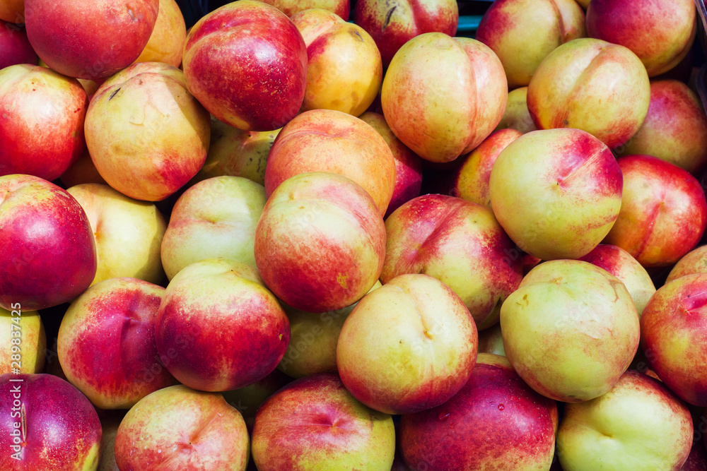 Background of ripe nectarines in the street market. Background of ripe nectarines in the street market.