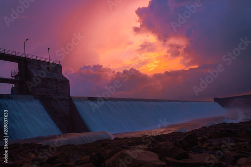 View of the Macchu Dam during sunset with clouds above it