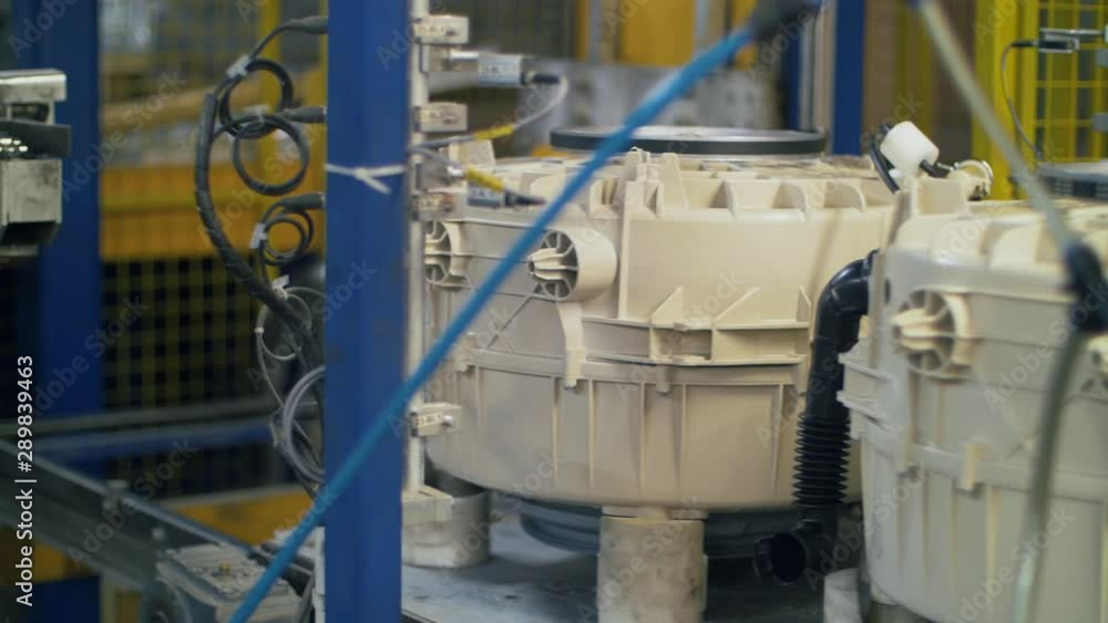 Washing machine details moving on conveyor belt on household appliances plant Washing machine details moving on conveyor belt on household appliances plant