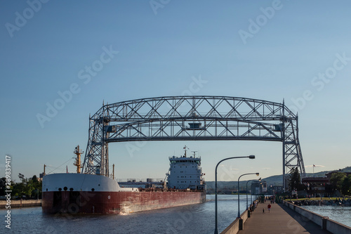 A Ship Passing Under Lift Bridge On Lake Superior