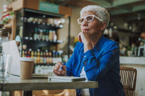 Serious lady with notes looking away stock photo